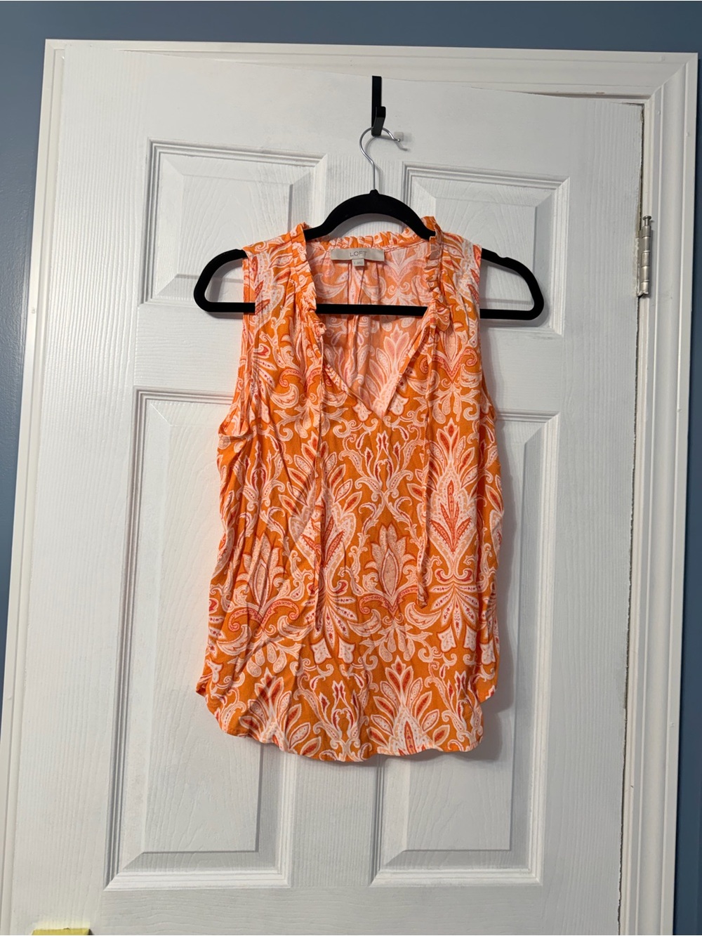 Loft sleeveless blouse in orange pattern and tie at the neckline size small